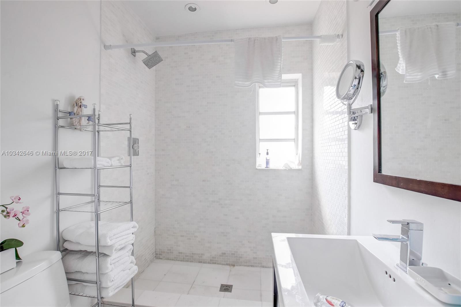 4300 Southwest 3rd Street Miami, FL 33134 - Photo 10 of 21 a bathroom with a bathtub a sink and a shower