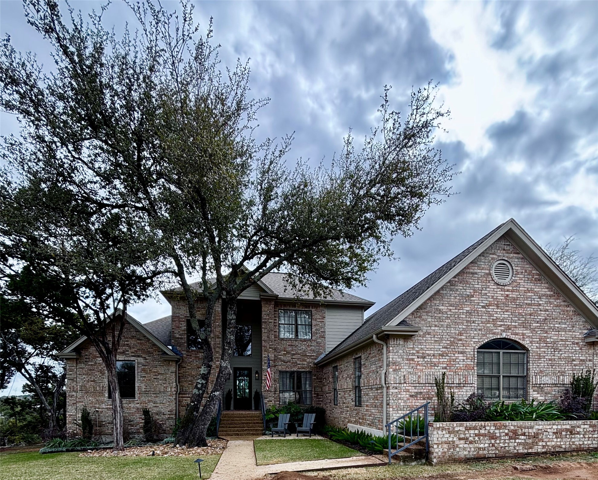 Traditional-style home with brick siding and roof with shingles