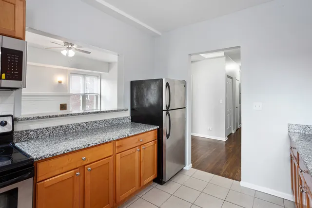 a kitchen with stainless steel appliances granite countertop a refrigerator and a sink