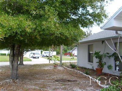 7286 Buchanan Road Fort Myers, FL 33967 - Photo 3 of 9 a view of a backyard with a tree