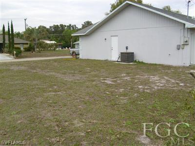 7286 Buchanan Road Fort Myers, FL 33967 - Photo 4 of 9 a big house with a big yard and large trees