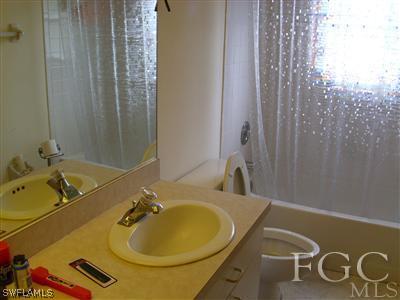 7286 Buchanan Road Fort Myers, FL 33967 - Photo 9 of 9 a bathroom with a sink and a mirror