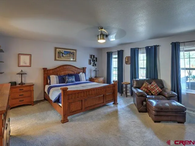 a bedroom with a bed and glass walk in closet