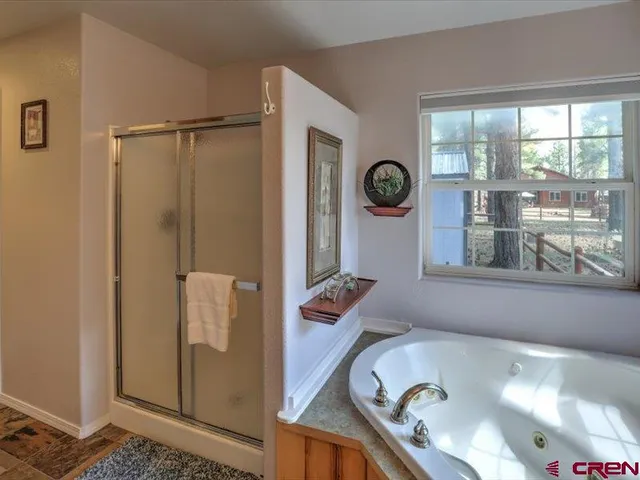 a bathroom with a tub and a shower