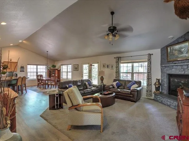 a living room with furniture a fireplace and a flat screen tv