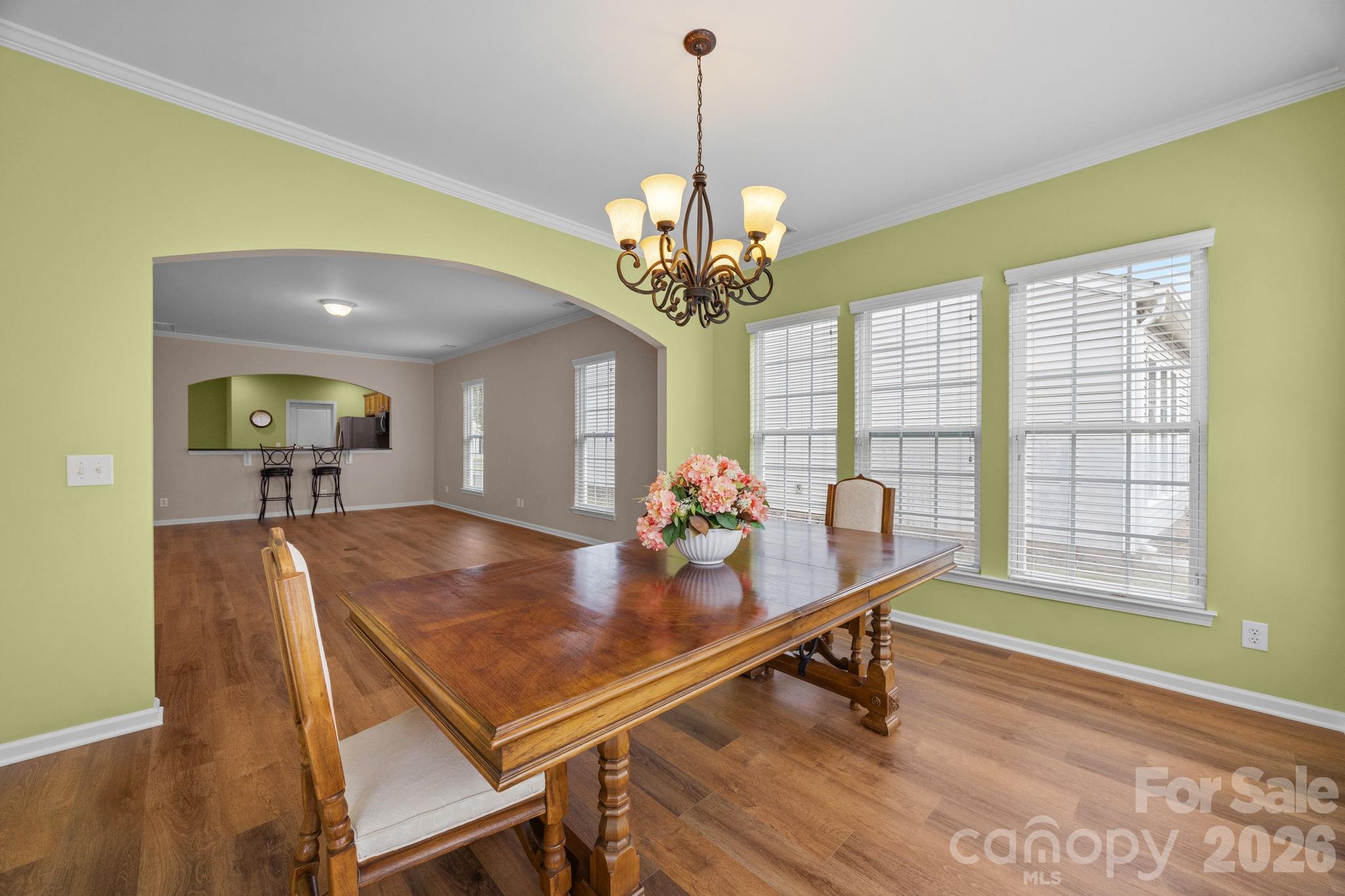 52062 Longspur Lane Fort Mill, SC 29707 - Photo 13 of 31 a dining room filled chandelier and wooden floor