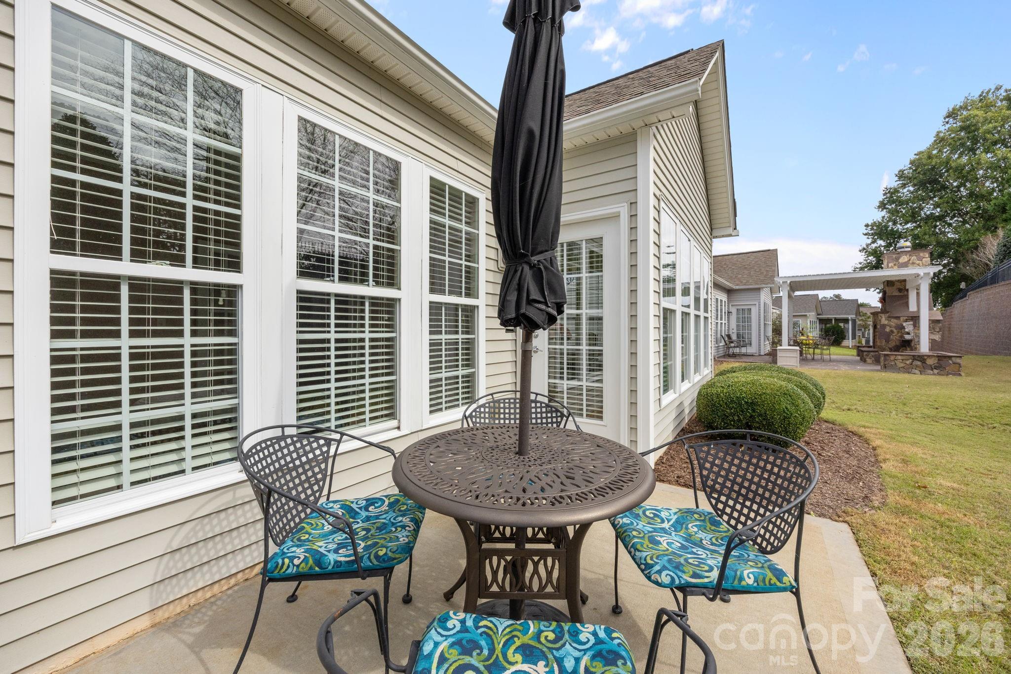 52062 Longspur Lane Fort Mill, SC 29707 - Photo 24 of 31 a backyard of a house with table and chairs