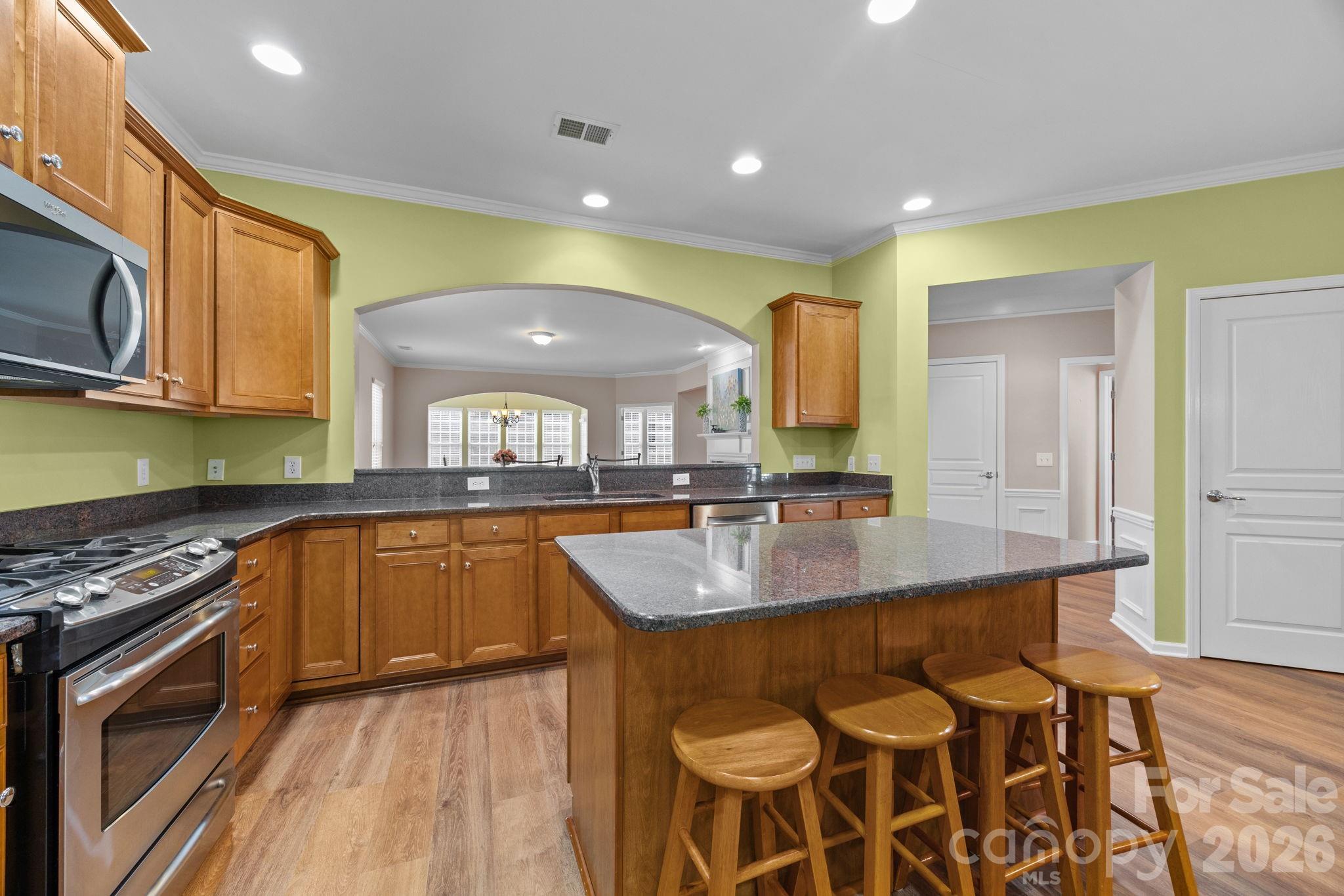 52062 Longspur Lane Fort Mill, SC 29707 - Photo 4 of 31 a kitchen with stainless steel appliances granite countertop a sink and a stove