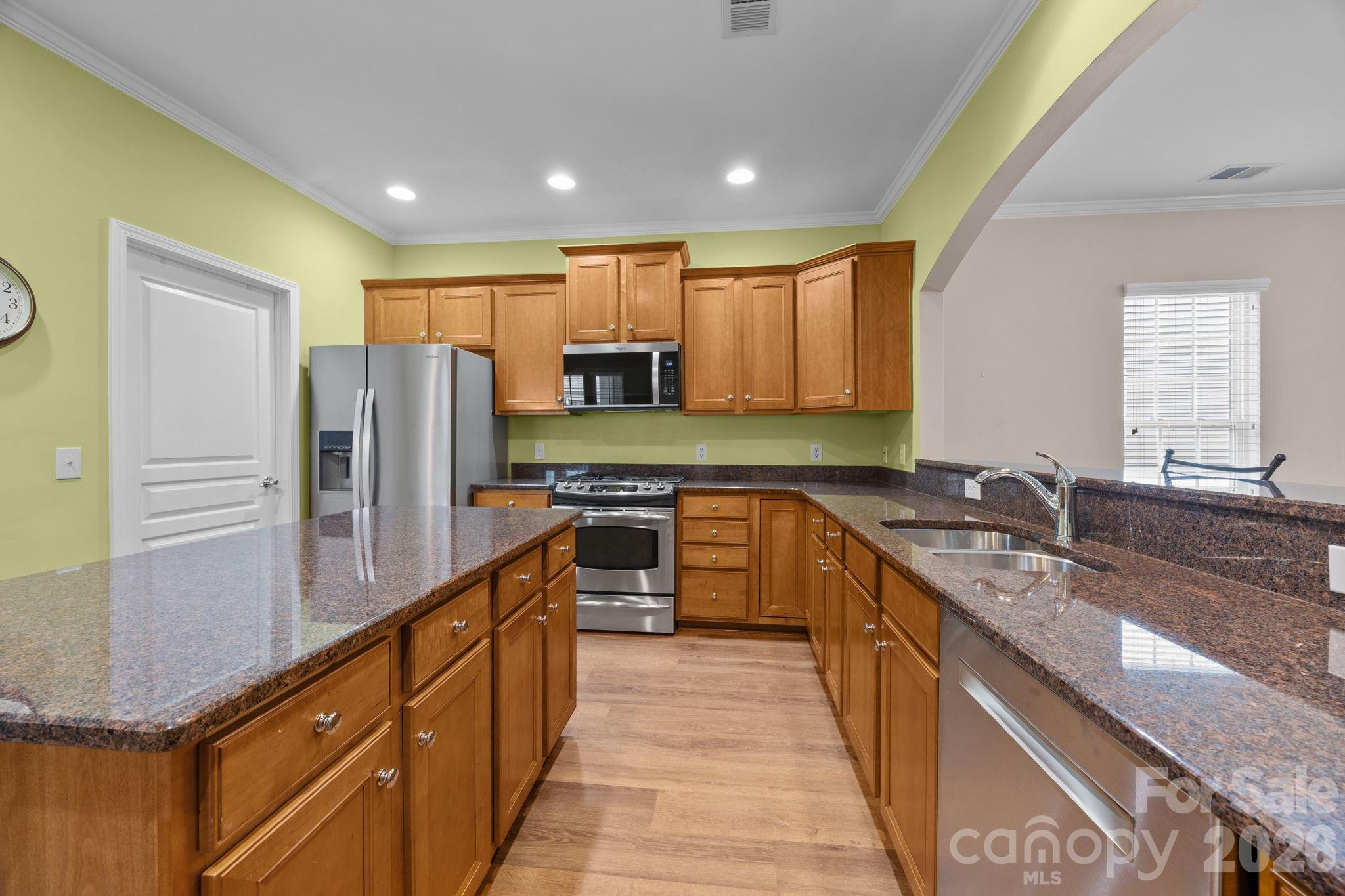 52062 Longspur Lane Fort Mill, SC 29707 - Photo 5 of 31 a kitchen with stainless steel appliances granite countertop a refrigerator a stove and a sink