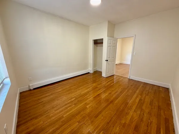 a view of an empty room and wooden floor