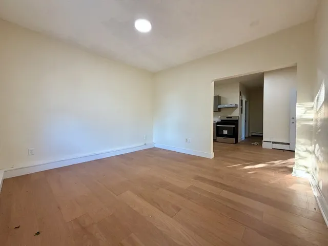 a view of empty room with a fireplace