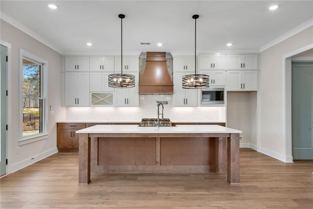 402 Manchester Lane Villa Rica, GA 30180 - Photo 12 of 63 a kitchen with stainless steel appliances granite countertop a sink a stove and a wooden floor