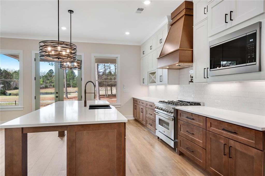 402 Manchester Lane Villa Rica, GA 30180 - Photo 13 of 63 a kitchen with stainless steel appliances granite countertop a sink a stove and a wooden floors
