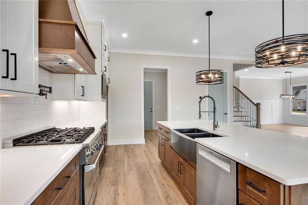 402 Manchester Lane Villa Rica, GA 30180 - Photo 14 of 63 a kitchen with stainless steel appliances granite countertop a stove and a sink