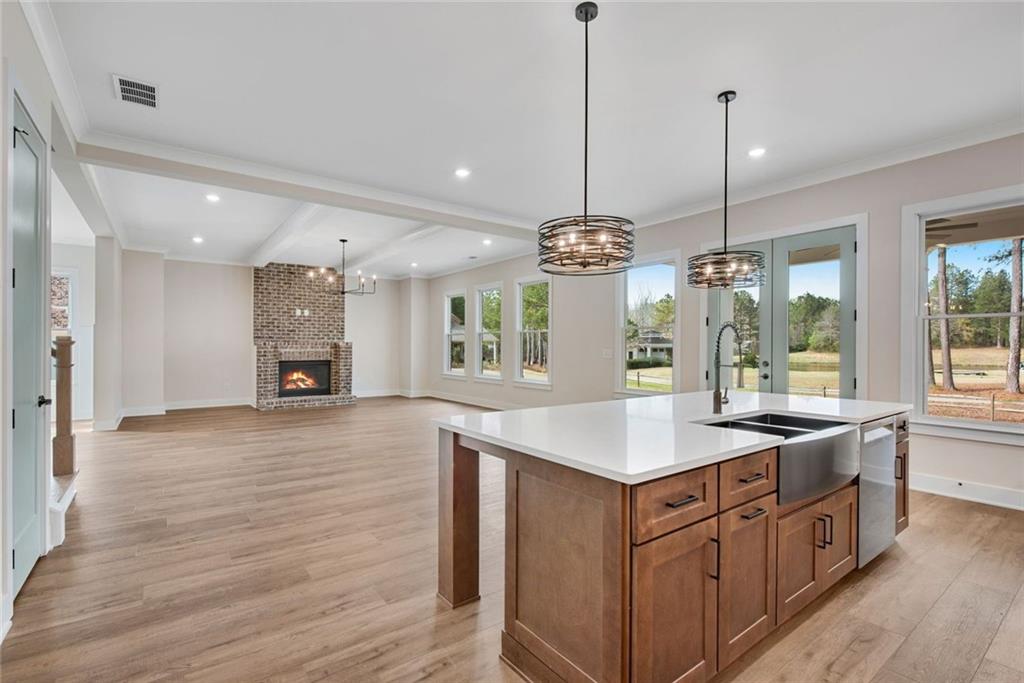 402 Manchester Lane Villa Rica, GA 30180 - Photo 15 of 63 a kitchen with kitchen island granite countertop a stove and a wooden floors