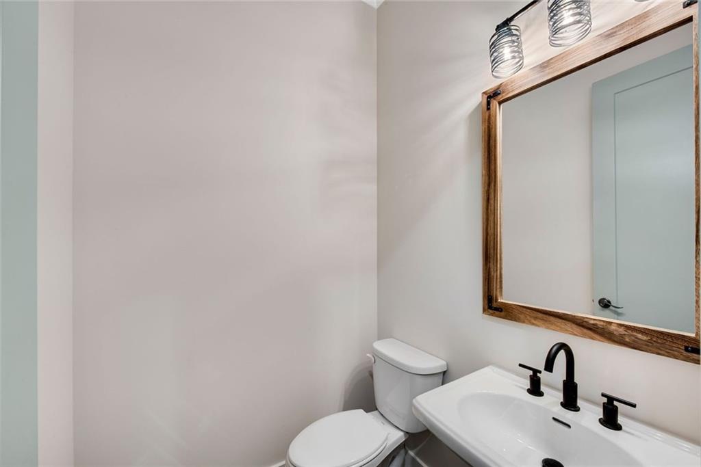 402 Manchester Lane Villa Rica, GA 30180 - Photo 17 of 63 a bathroom with a toilet sink and mirror