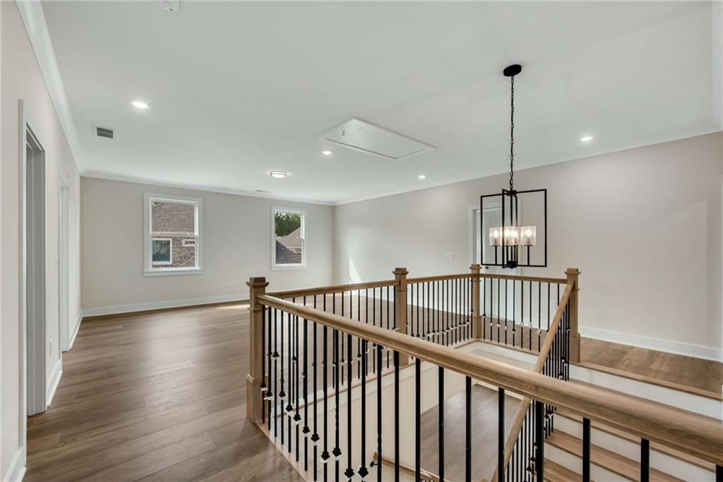 402 Manchester Lane Villa Rica, GA 30180 - Photo 19 of 63 a view of hallway with wooden floor and chandelier