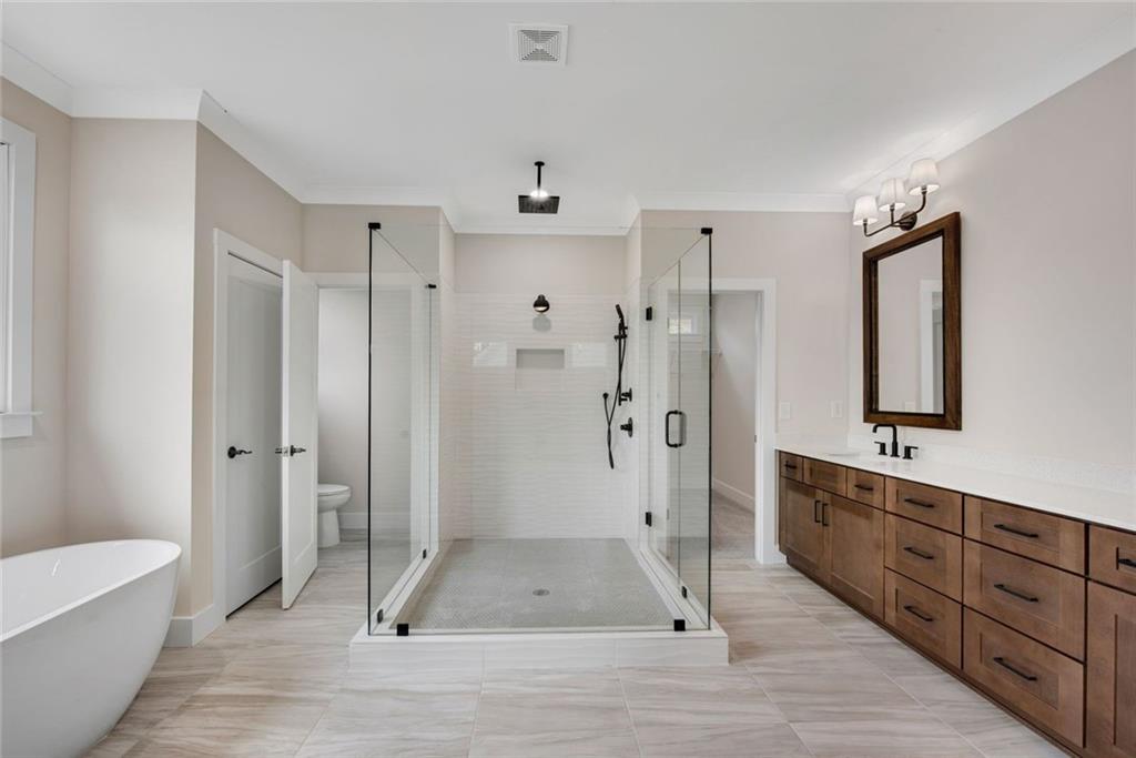 402 Manchester Lane Villa Rica, GA 30180 - Photo 24 of 63 a bathroom with a glass shower door a sink and a bathtub