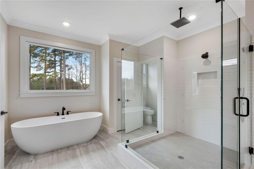 402 Manchester Lane Villa Rica, GA 30180 - Photo 25 of 63 a bathroom with a bathtub and a shower