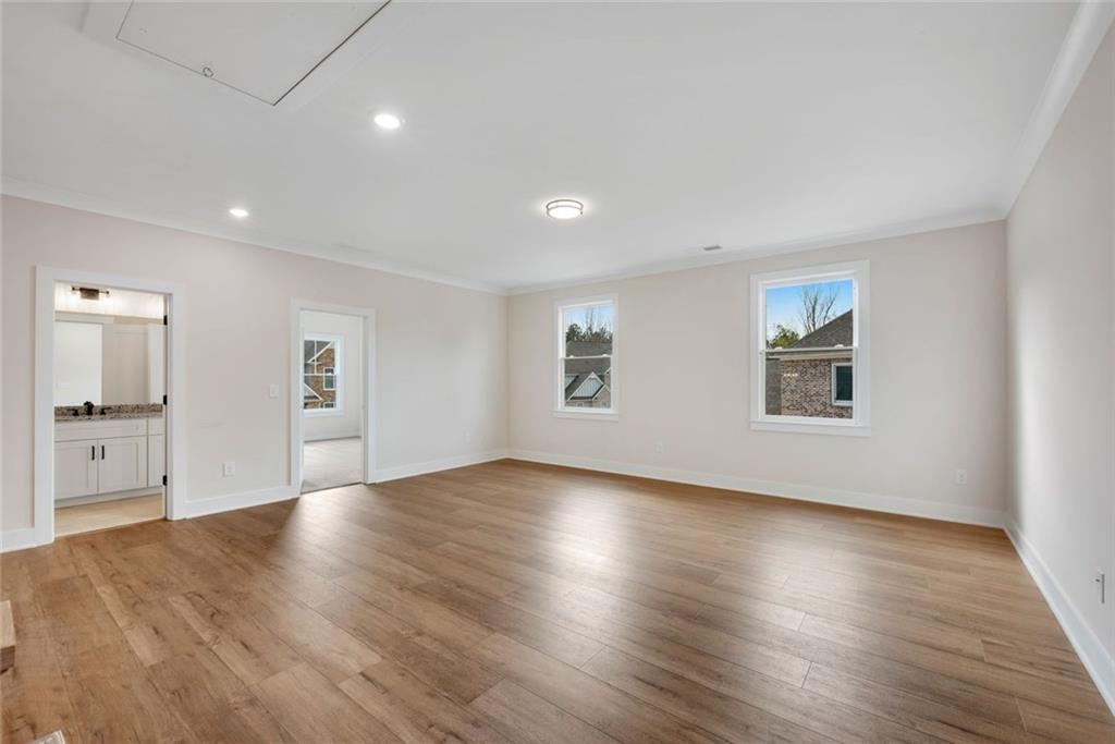 402 Manchester Lane Villa Rica, GA 30180 - Photo 31 of 63 a view of an empty room with wooden floor and a window