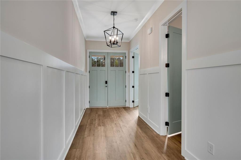 402 Manchester Lane Villa Rica, GA 30180 - Photo 4 of 63 a view of a hallway with wooden floor and staircase