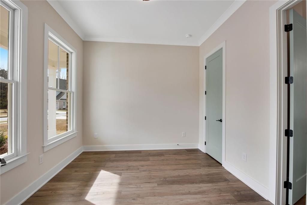 402 Manchester Lane Villa Rica, GA 30180 - Photo 7 of 63 an empty room with wooden floor and windows