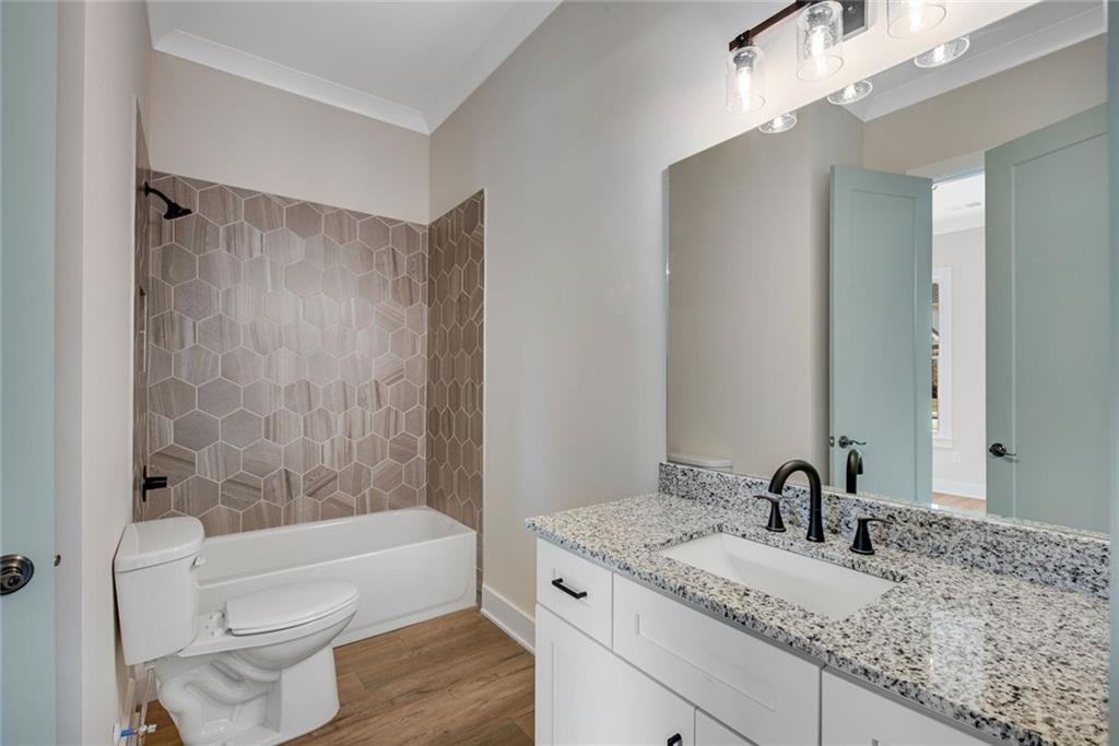 402 Manchester Lane Villa Rica, GA 30180 - Photo 8 of 63 a bathroom with a granite countertop sink a toilet and bathtub