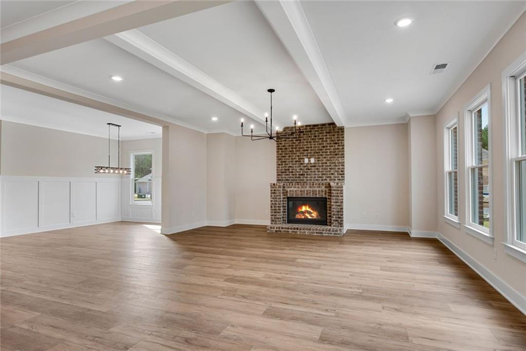 402 Manchester Lane Villa Rica, GA 30180 - Photo 10 of 63 a view of an empty room with a fireplace and a window