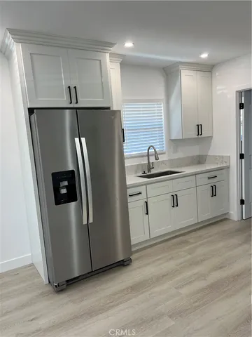 a kitchen with stainless steel appliances a refrigerator a sink a stove a microwave and island