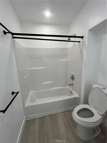 a bathroom with a toilet and a bathtub