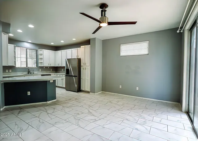 a kitchen with stainless steel appliances granite countertop a refrigerator sink and cabinets