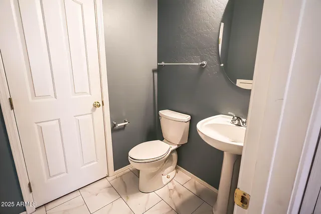 a white toilet sitting next to a shower