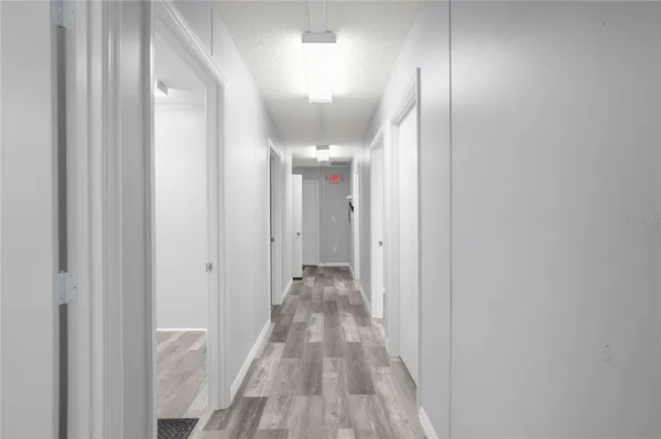a view of a hallway with wooden floor