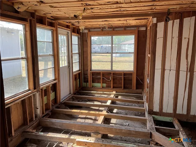 a kitchen with a sink and wooden floor