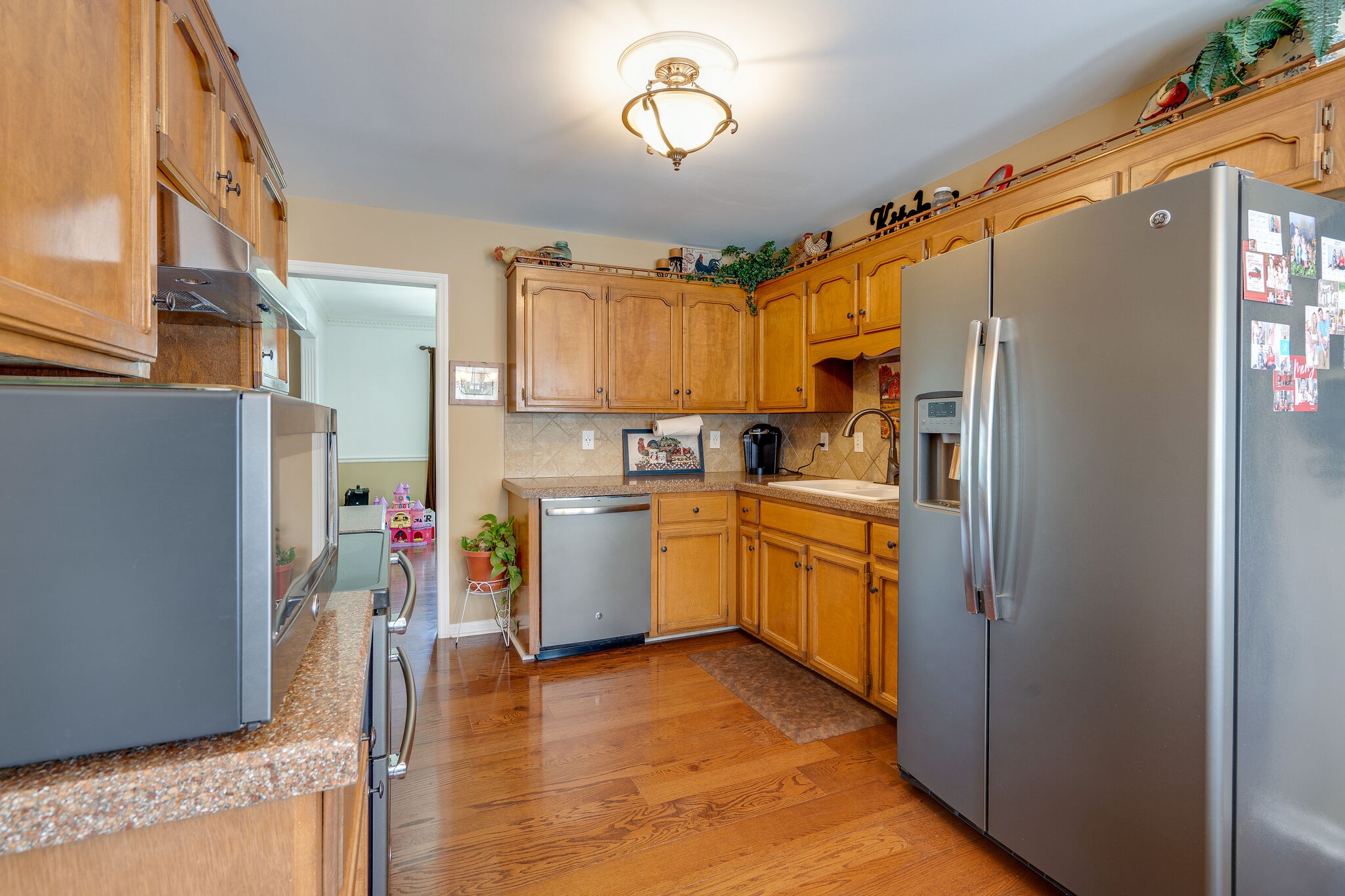 1011 Green Acres Road Joelton, TN 37080 - Photo 12 of 31 a kitchen with refrigerator cabinets and wooden floor