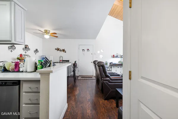 a dining room with furniture and wooden floor