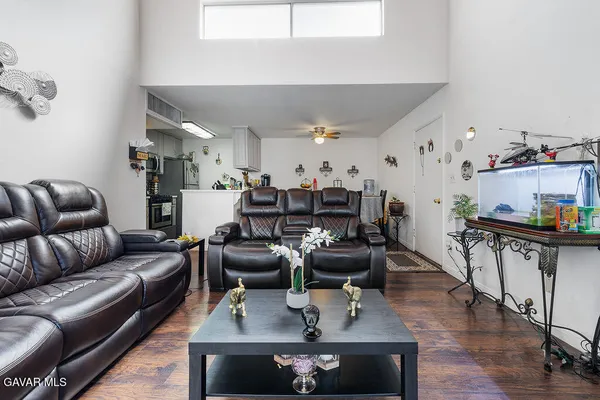 a living room with furniture and wooden floor