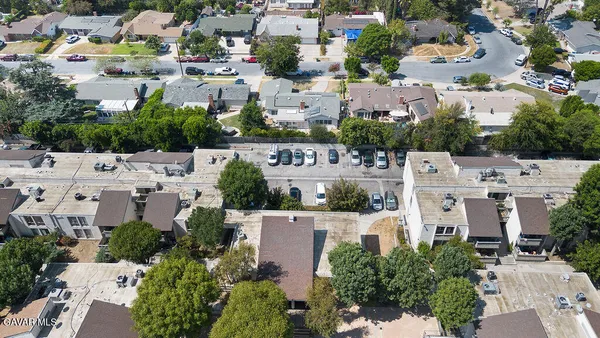 an aerial view of residential houses with outdoor space