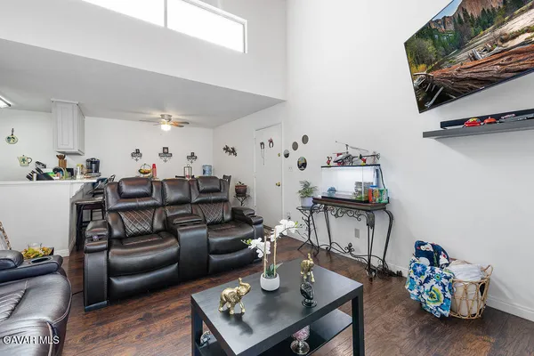 a living room with furniture and wooden floor