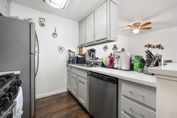 a kitchen with stainless steel appliances a refrigerator and cabinets