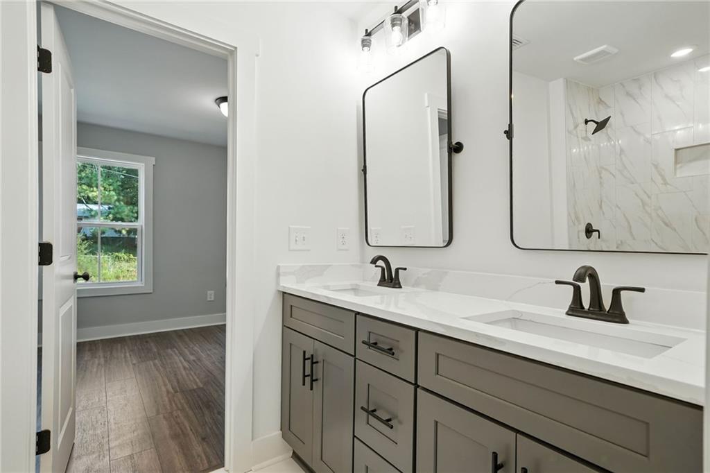 125 Old Alabama Road Southeast Emerson, GA 30137 - Photo 26 of 37 a bathroom with a double vanity sink mirror and shower