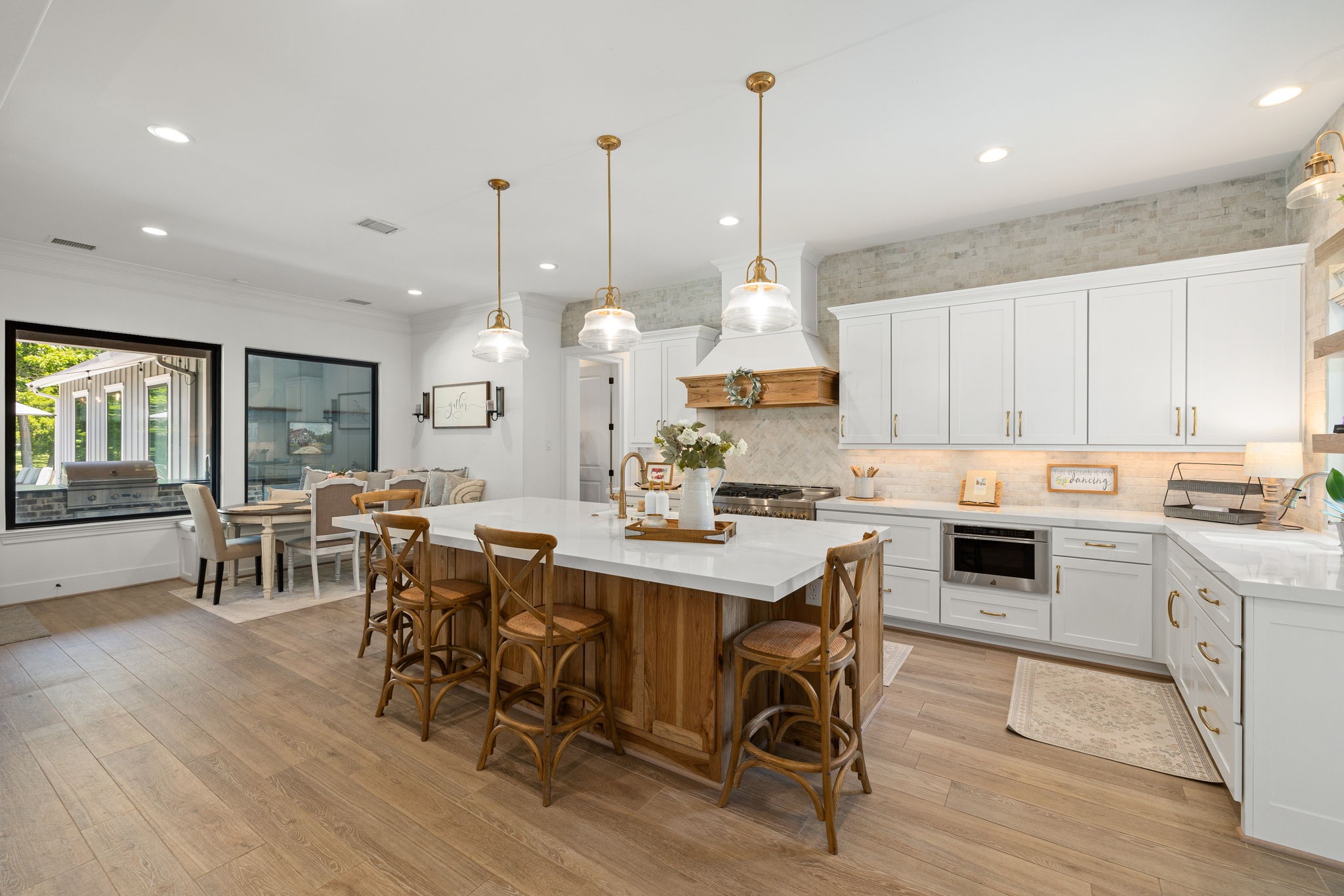 4311 Upper Oxbow Trace Fulshear, TX 77441 - Photo 11 of 49 Chef’s kitchen with oversized island, custom cabinetry, and designer finishes.
