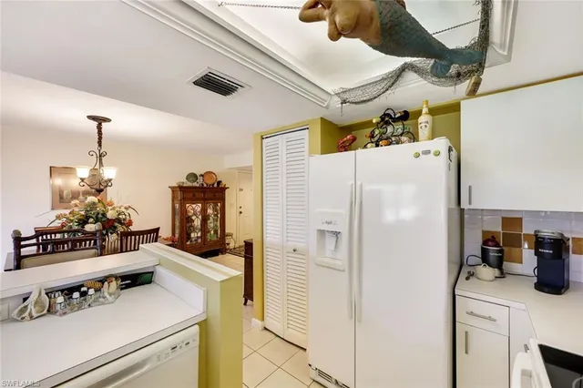 a white refrigerator freezer sitting inside of a kitchen