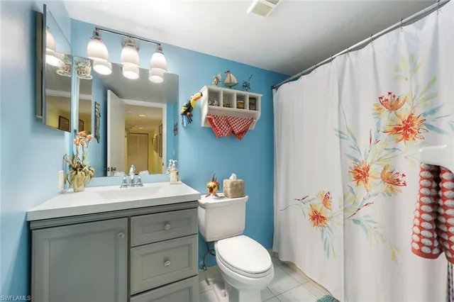 a bathroom with a sink mirror vanity and toilet