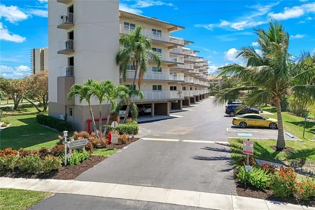 a front view of a house with a garden and plants