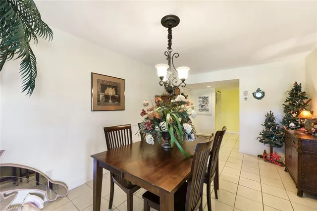 a view of a dining room with furniture and chandelier