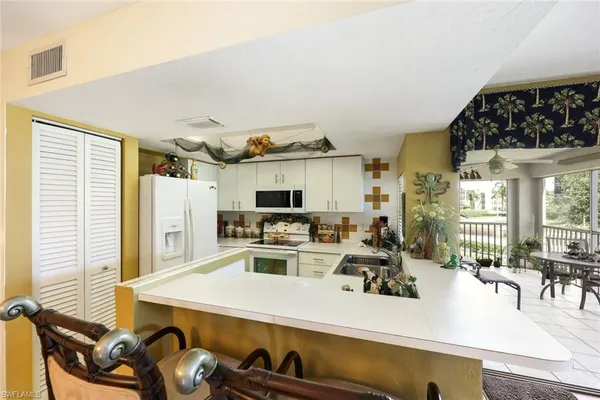 a kitchen with a sink appliances and cabinets