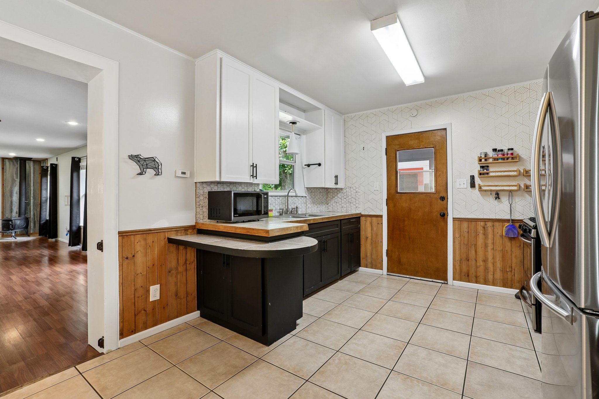 1114 West 2nd Street Elgin, TX 78621 - Photo 6 of 31 A well-lit kitchen with natural wood accents and a practical layout.
