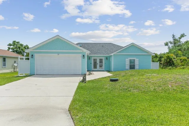 a view of a house with a yard and garage