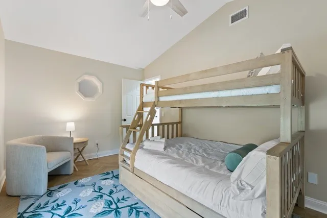 a bedroom with a large bed and a chandelier